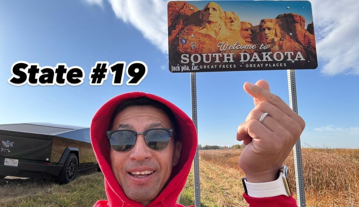 Chong Kim poses near a South Dakota sign during his 50StatesofPickleball challenge trip