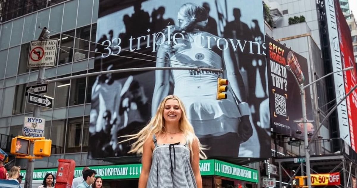 Anna Leigh Waters in front of a billboard highlighting her pickleball accomplishments in Times Square, New York City.