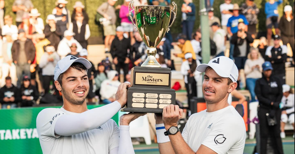 Ben and Collin Johns hold a trophy after a pickleball tournament.
