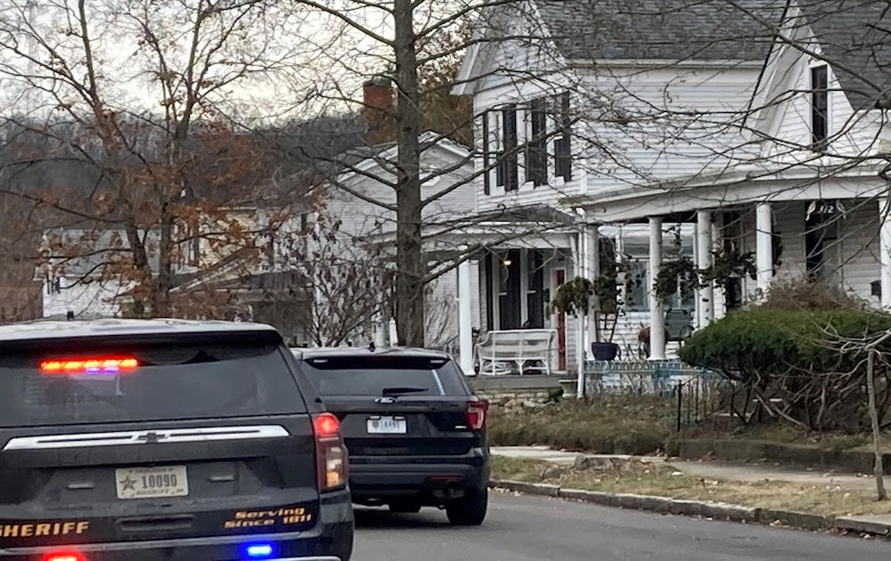 Law enforcement vehicles parked outside the Indiana home of Rodney Grubbs.