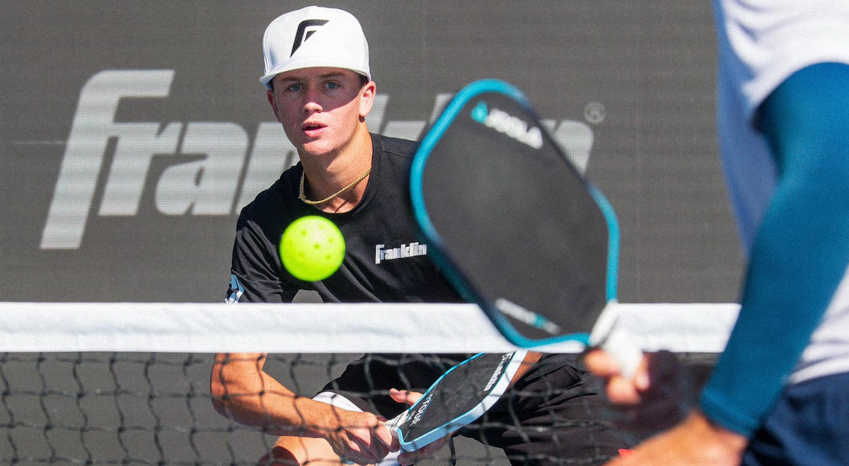 Hayden Patriquin hits a shot against Ben Johns during a pickleball match.