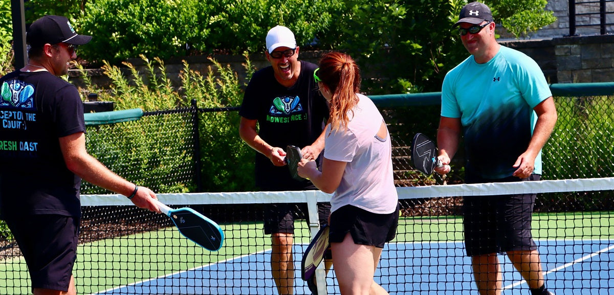 People enjoying themselves playing pickleball