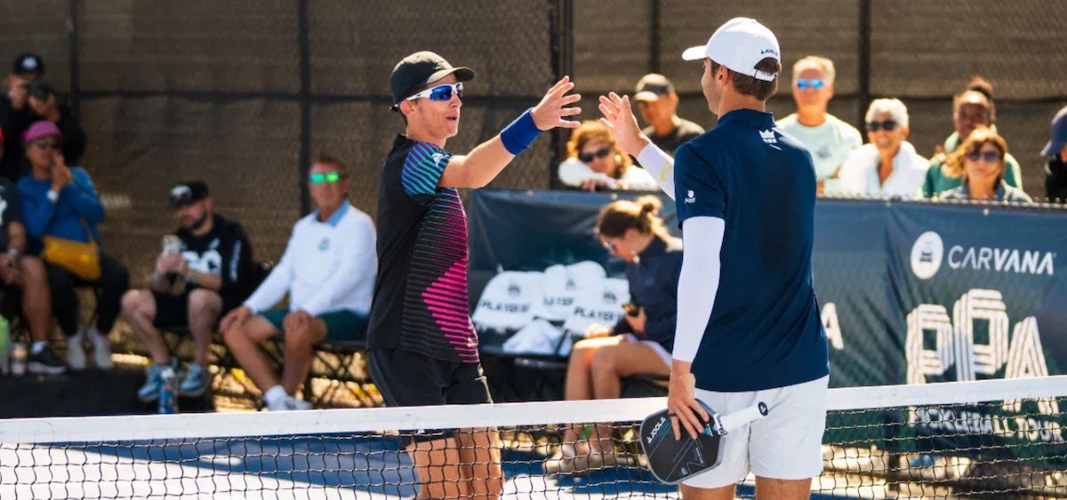 John Lucian Goins shakes hands with Ben Johns after a PPA Tour pickleball match.