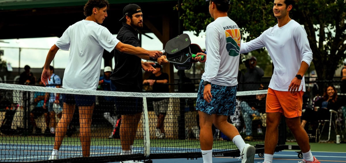 Players tap paddles after a pickleball game.