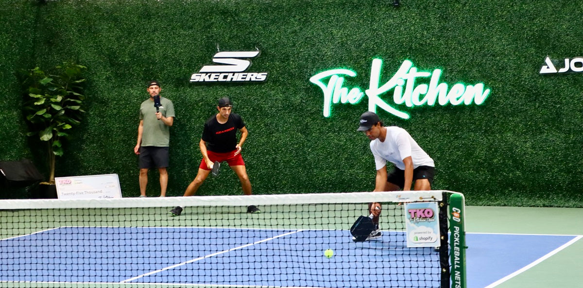 A pickleball player tries to regain control of the point mid-match
