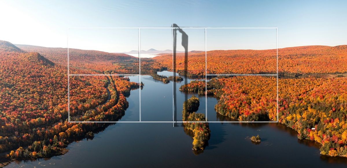 A transparent pickleball court outline set against the backdrop of an autumnal New England scene