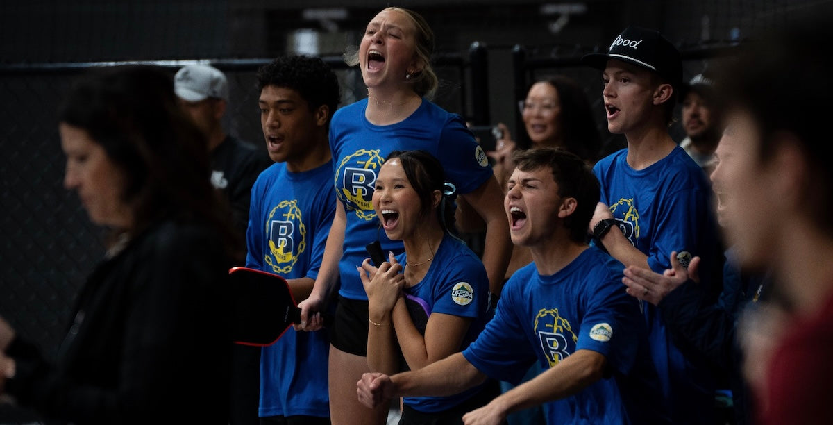 Utah high school pickleball players celebrate during a match.
