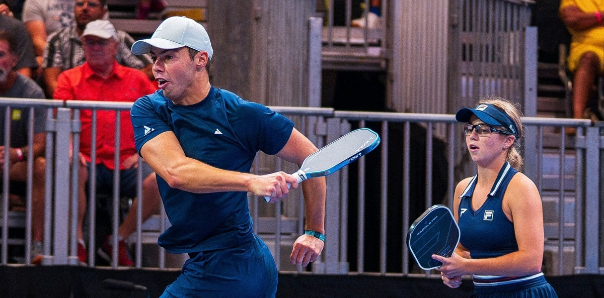 Ben Johns poaching a pickleball opportunity from partner Anna Leigh Waters