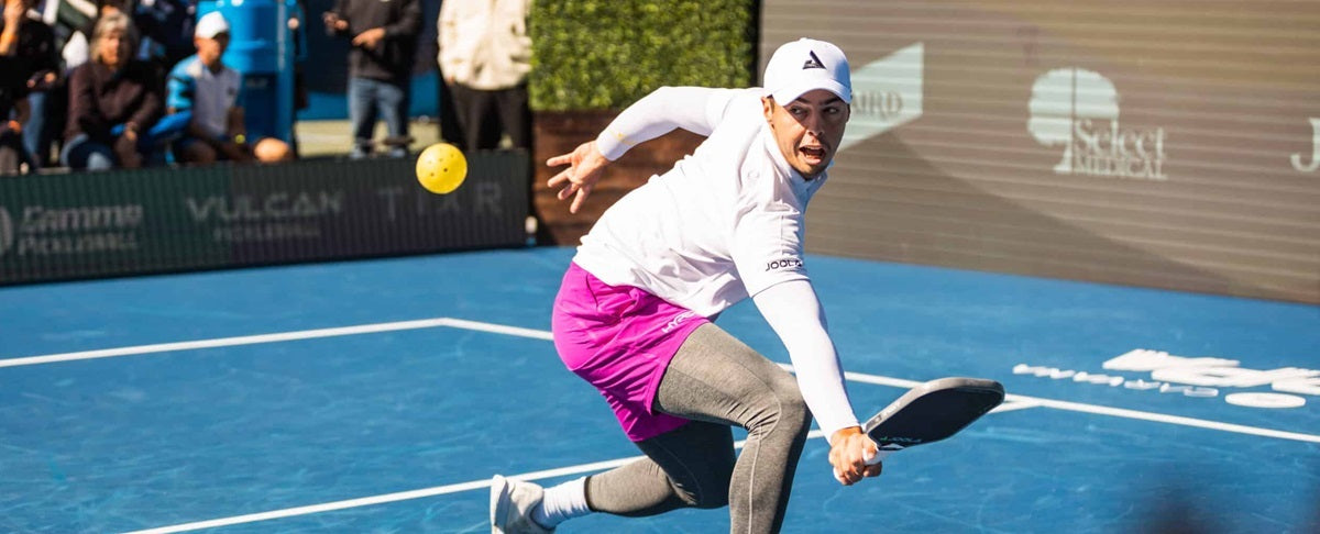 Ben Johns reaches for a return during a pickleball match