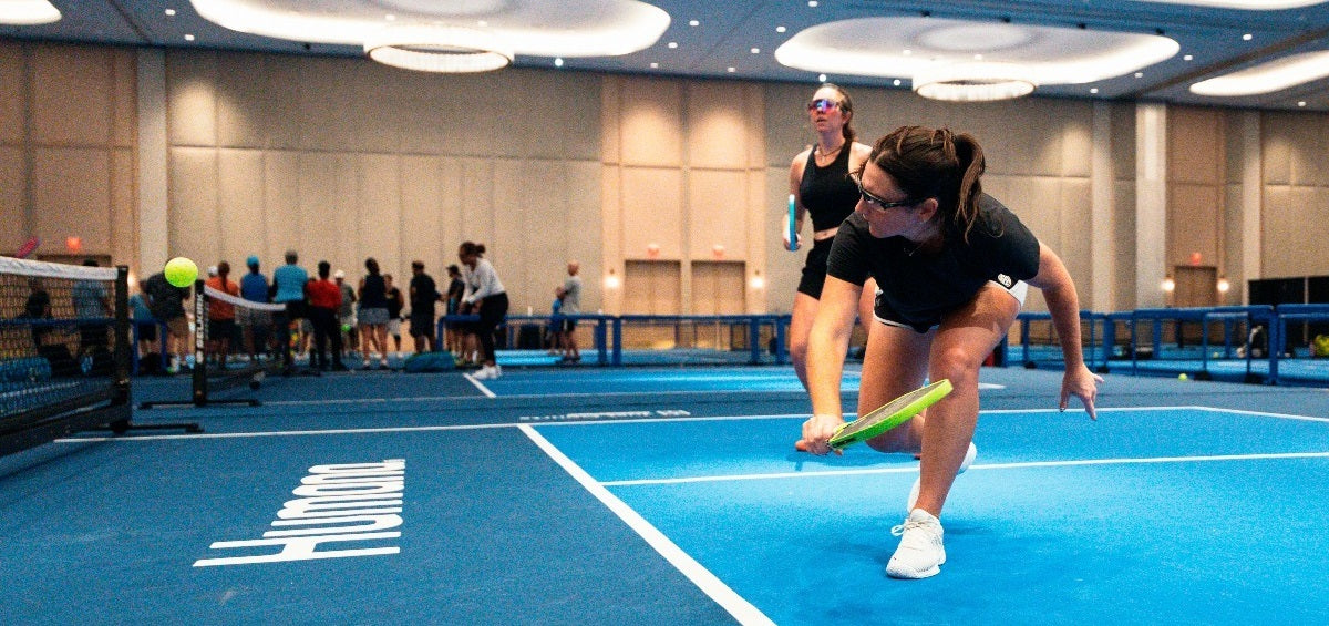 Rachel Rohrabacher during a professional pickleball match, executing a drop volley