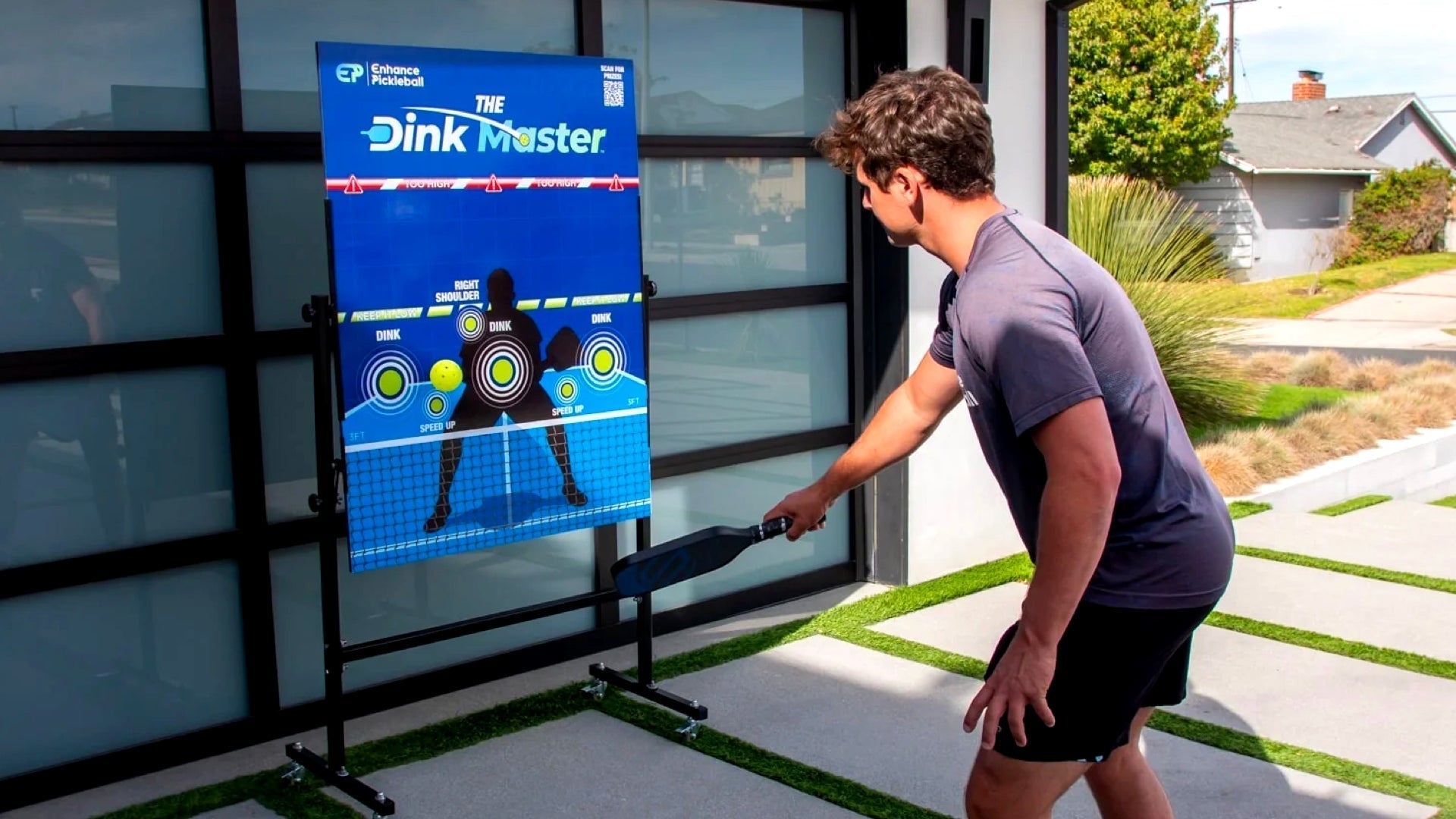 A man uses The Dink Master training board.