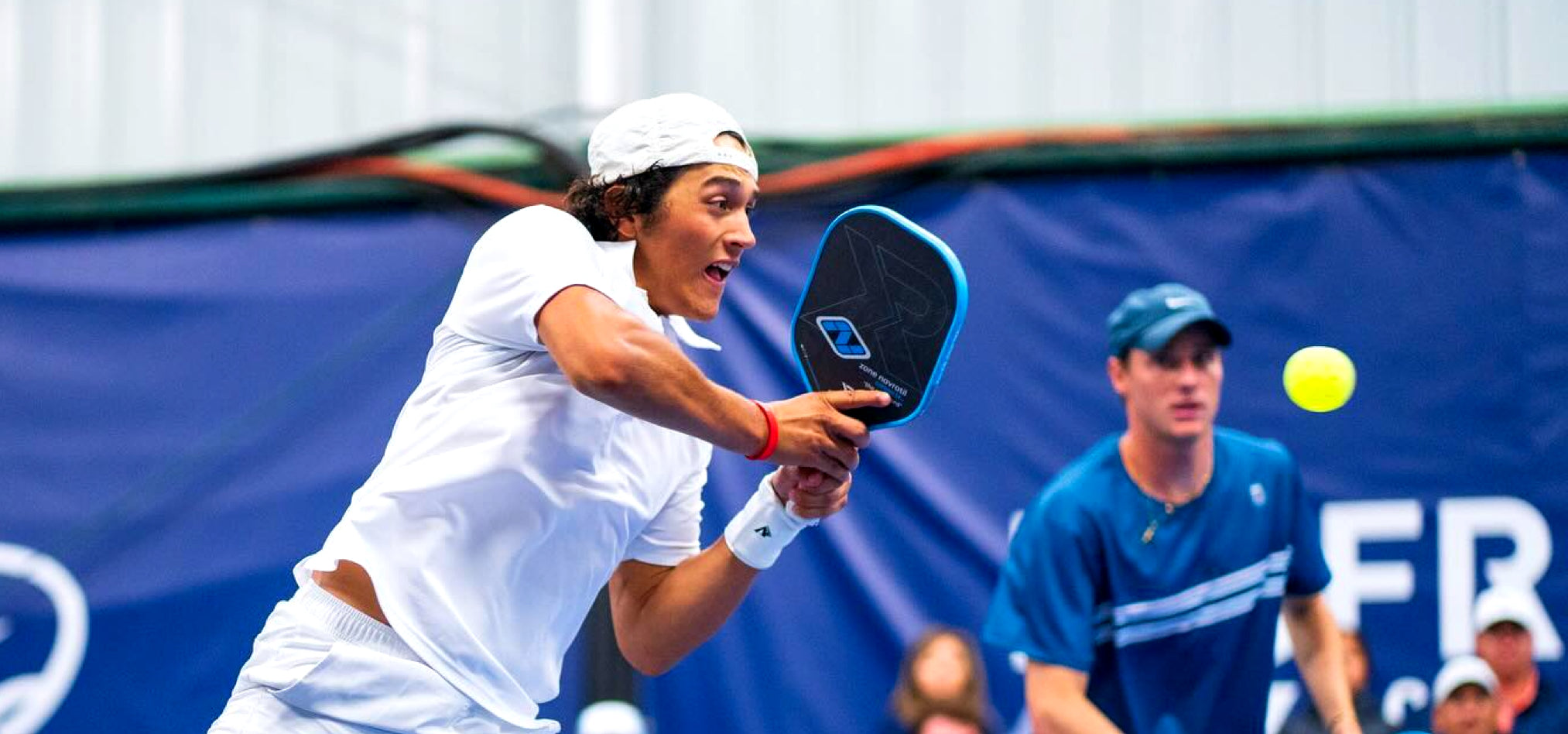 Jack Munro, a young pickleball pro player, in the middle of a point.