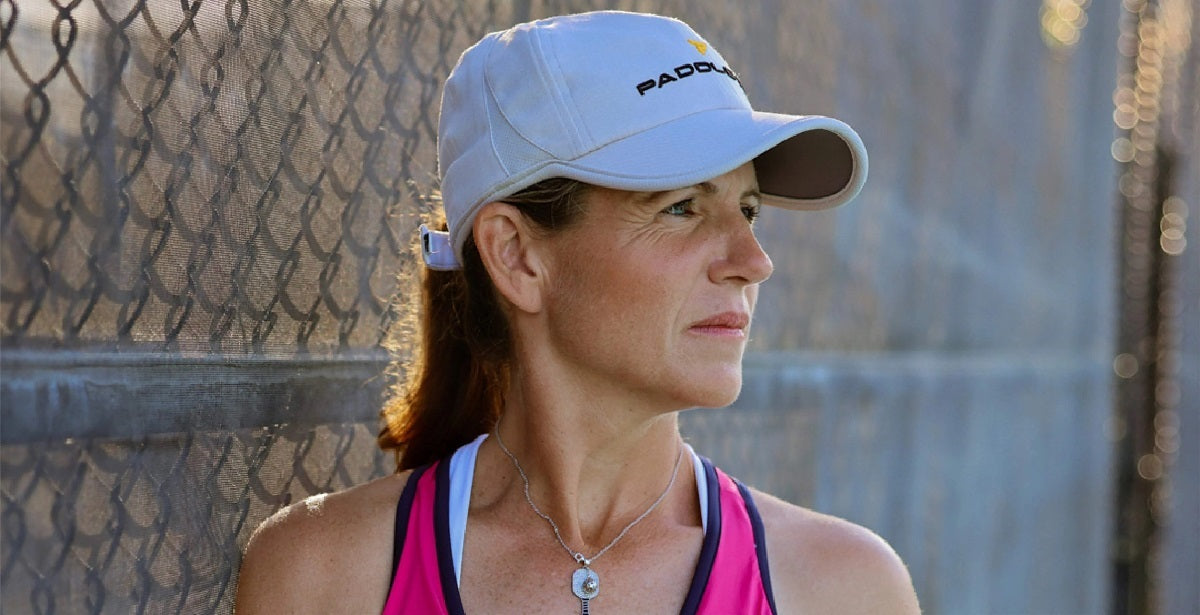 A profile shot of pickleball pro Leigh Waters near a court