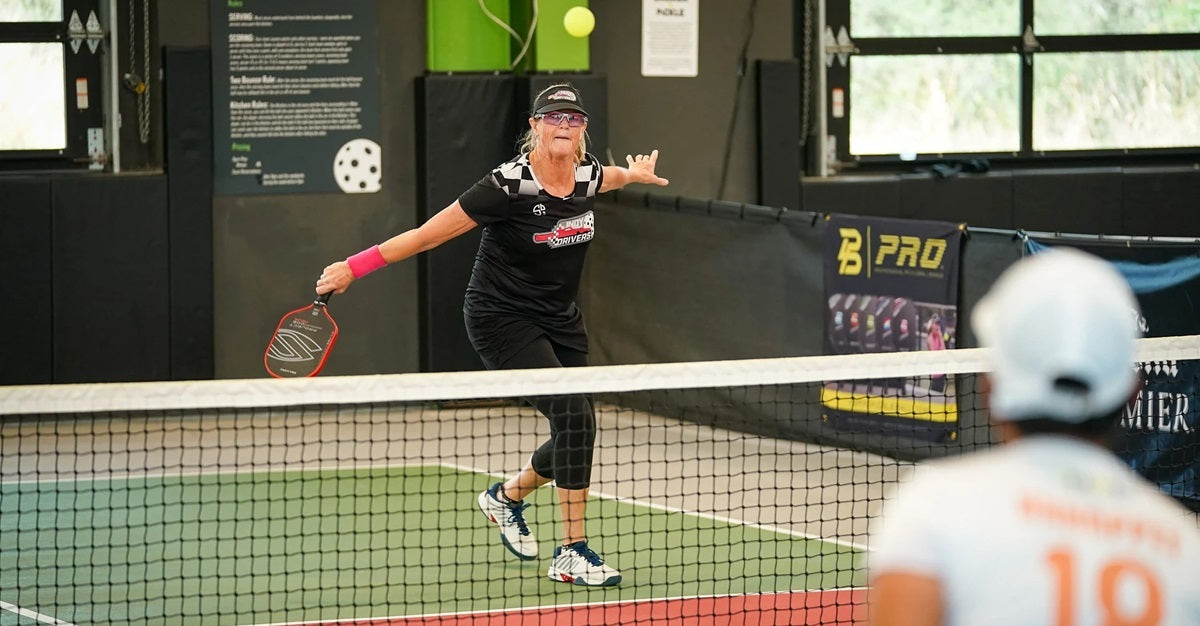 Senior players battle in a game of pro-level pickleball