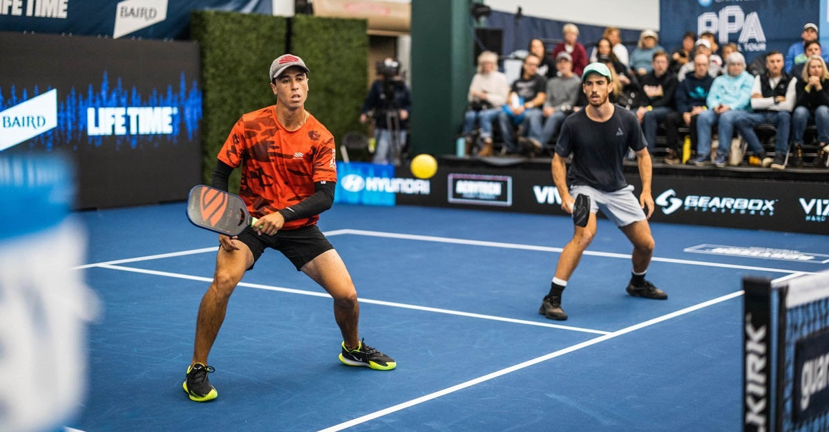 Pablo Tellez, a pro pickleball lefty, about to hit a backhand mid-match.