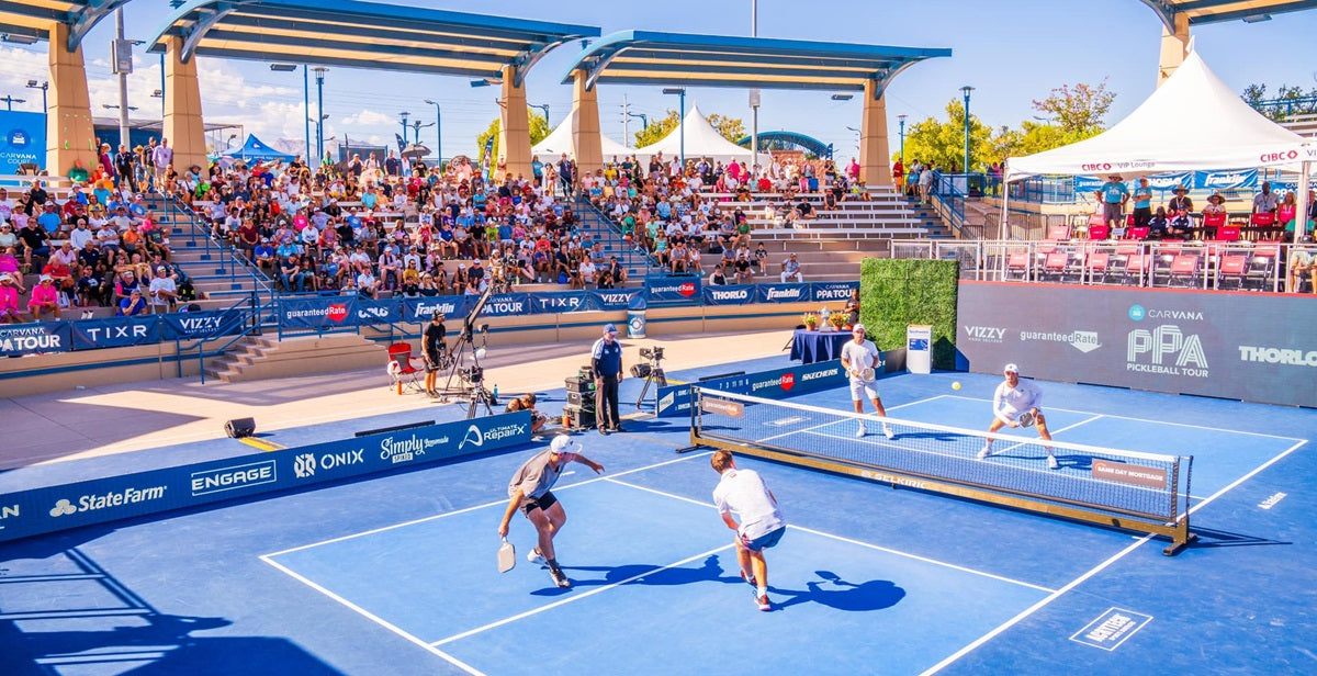 Still from a PPA Tour match, a doubles player about to hit a ball