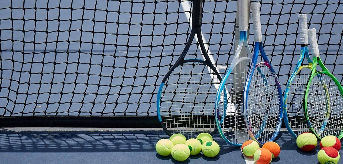 USTA Image of tennis racquets on a pickleball court and redball tennis