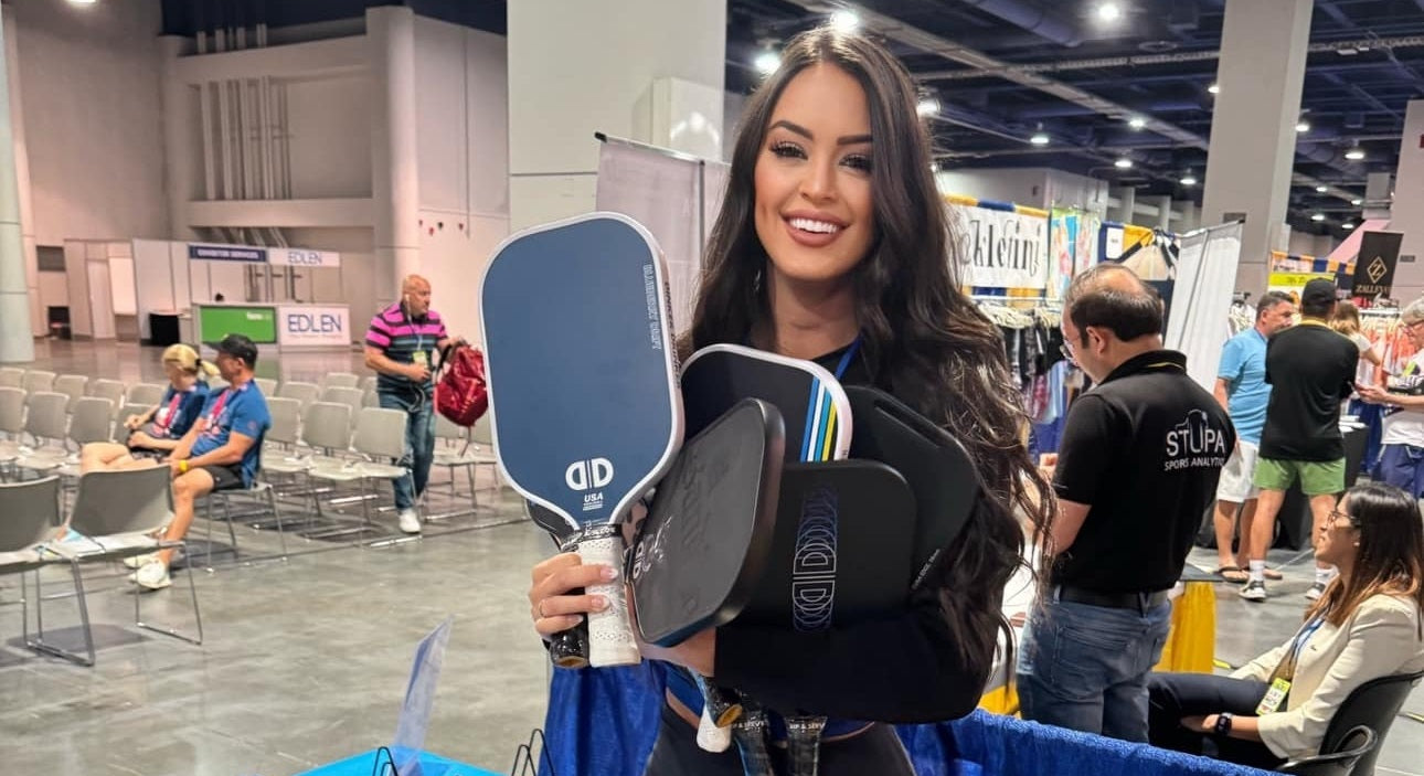 Rachel Stuhlmann posing with pickleball paddles