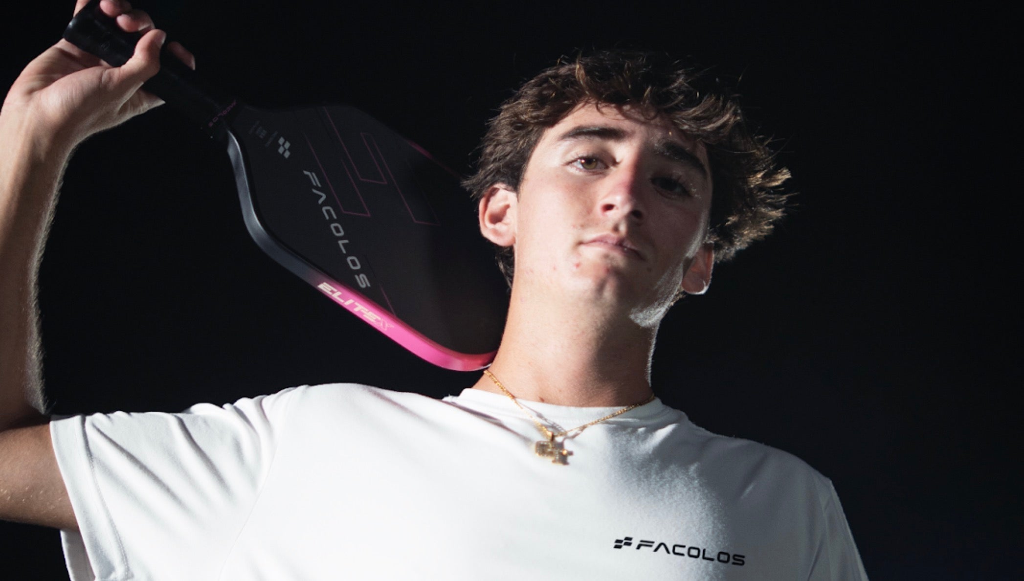 Gabe Tardio holds a Facolos pickleball paddle.