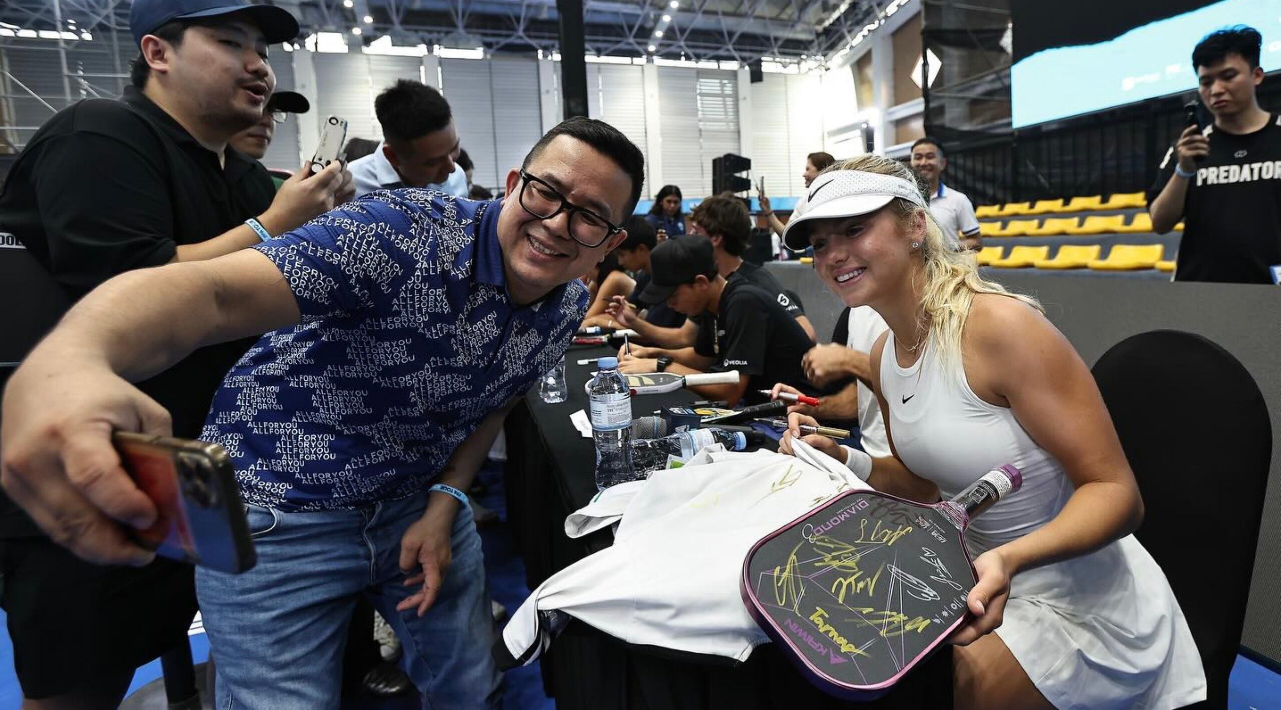 Anna Leigh Waters takes a photo with a fan in Vietnam.