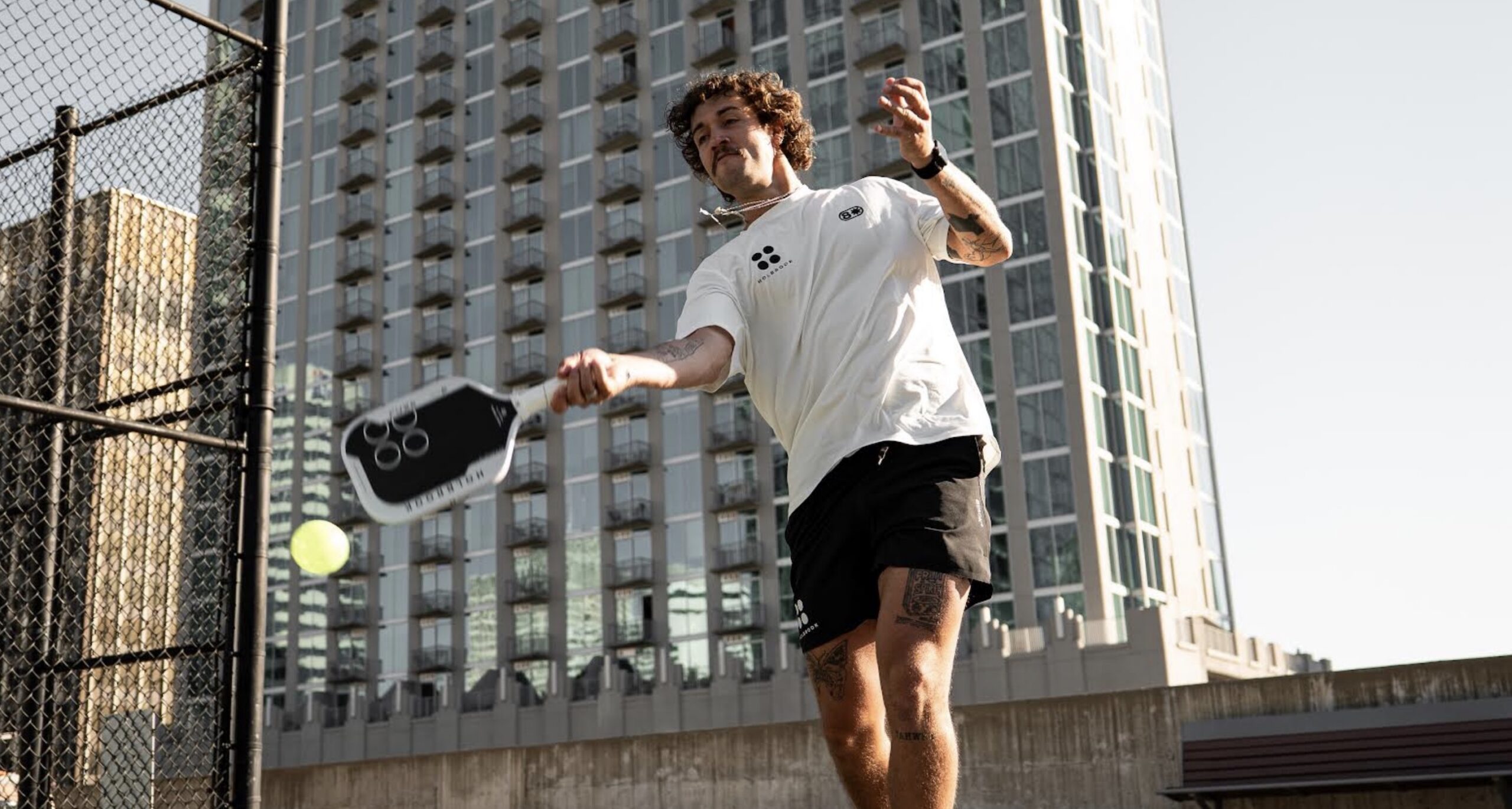 Michael Loyd hits a shot with the new Holbrook Fuze pickleball paddle.