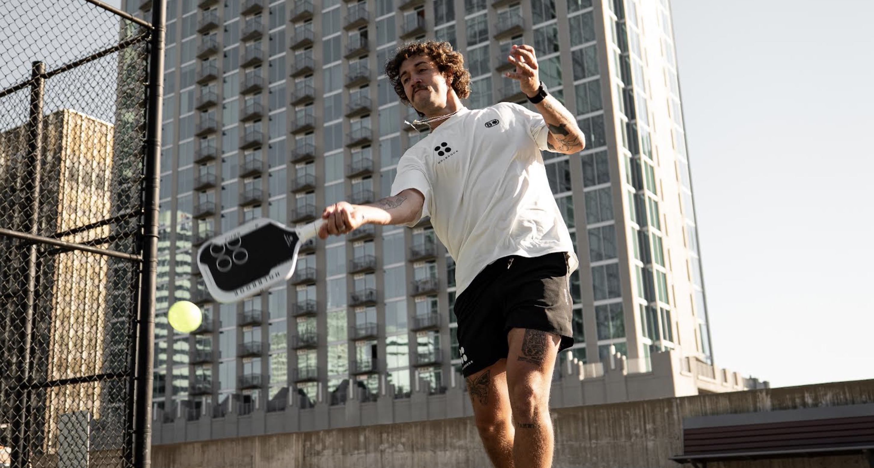 Michael Loyd hits a shot with the new Holbrook Fuze pickleball paddle.
