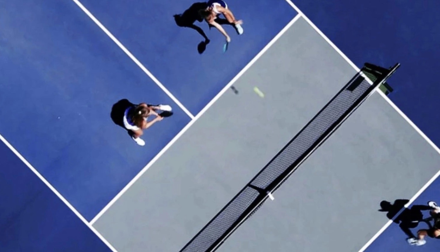 Aerial view of players on a pickleball court.