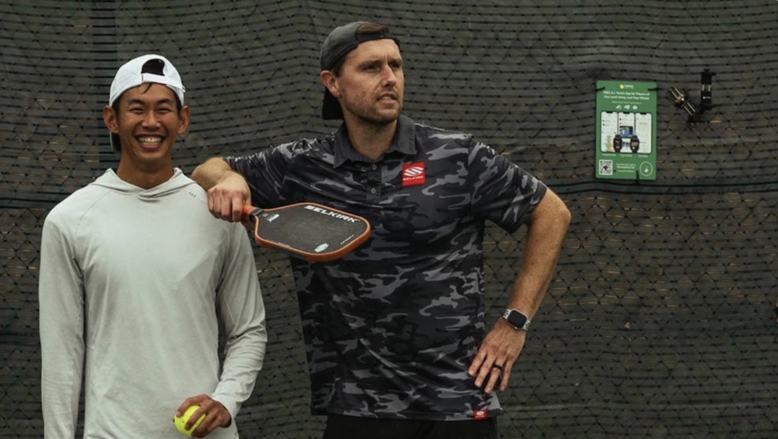 Two pickleball players take a break between points.