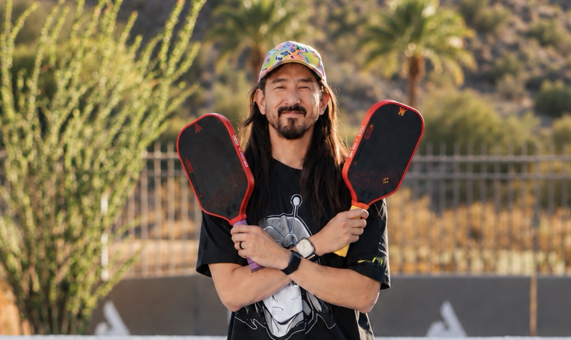 DJ and producer Steve Aoki holds his new JOOLA collab pickleball paddles.